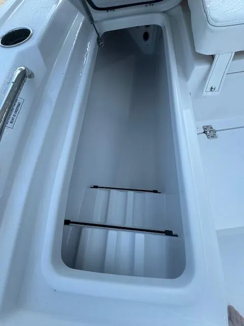 Slide: The Image of 2025 Sportsman Masters 247 Bay Boat storage compartment, open and empty. - 6