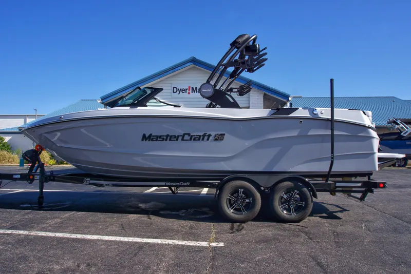 Slide: The Image of 2025 MasterCraft XT23 boat on trailer in parking lot. - 12