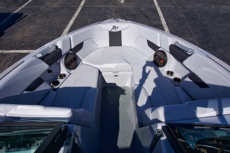 Slide: The Image of 2025 MasterCraft XT23 boat interior with sleek seating and modern design. - 16