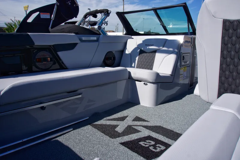 Slide: The Image of 2025 MasterCraft XT23 boat interior with sleek seating and modern design. - 18