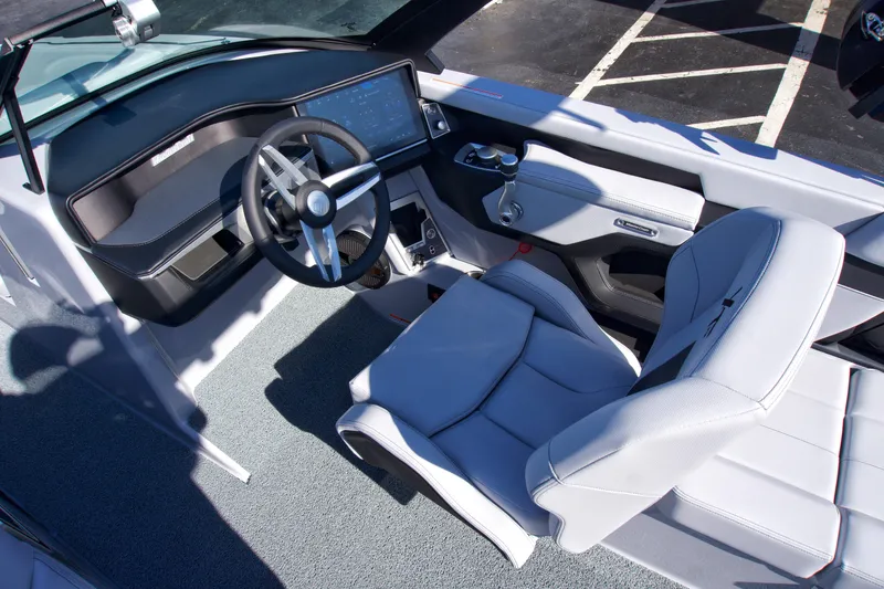 Slide: The Image of 2025 MasterCraft XT23 boat interior with modern dashboard and comfortable seating. - 19
