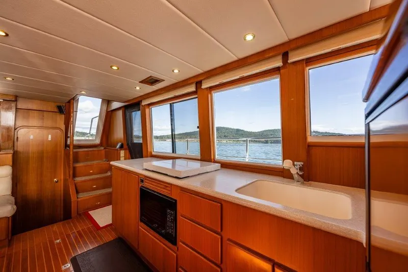 Slide: The Image of Interior of 2000 Symbol 42 Classic Trawler with wood finish and scenic windows. - 10