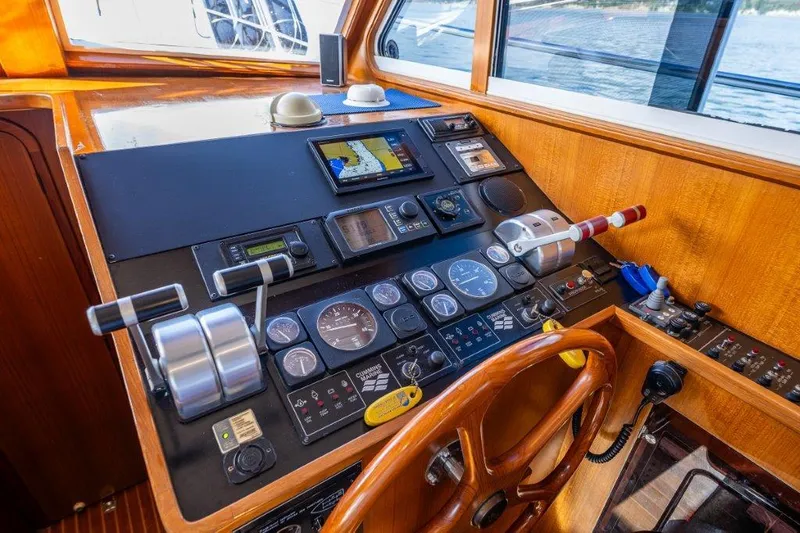 Slide: The Image of Control panel of 2000 Symbol 42 Classic Trawler with navigation instruments and wooden steering wheel. - 15