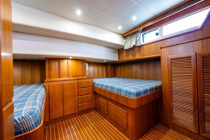 Slide: The Image of Cozy cabin interior of 2000 Symbol 42 Classic Trawler with twin beds and wooden finish. - 17