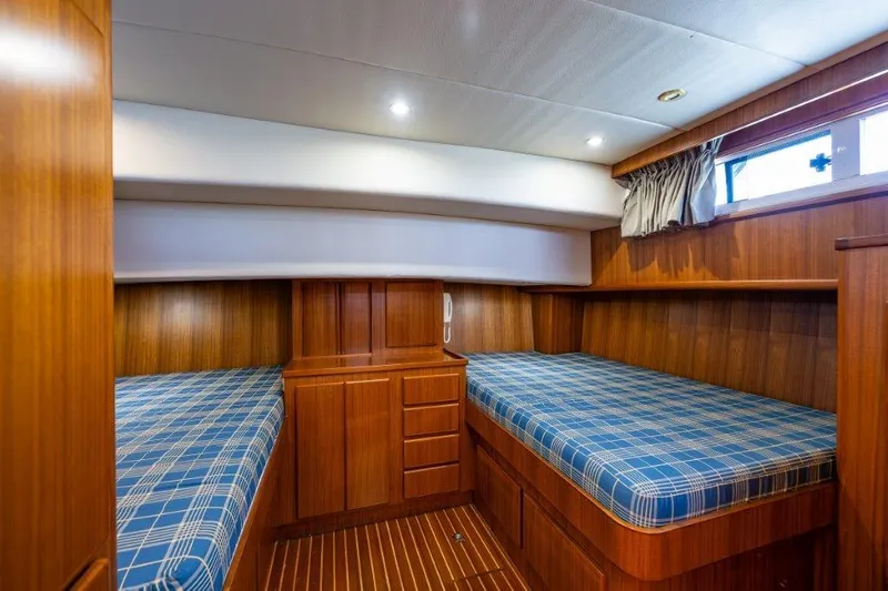 Slide: The Image of Cozy cabin interior of 2000 Symbol 42 Classic Trawler with twin beds and wood paneling. - 19