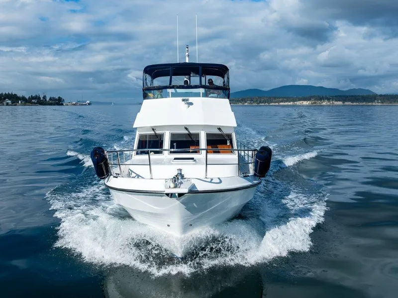 Slide: The Image of Symbol 42 Classic Trawler 2000 cruising on calm waters under a cloudy sky. - 2