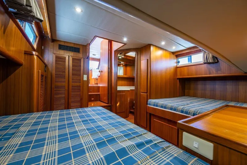 Slide: The Image of Cozy cabin interior of 2000 Symbol 42 Classic Trawler with wood paneling and twin beds. - 20