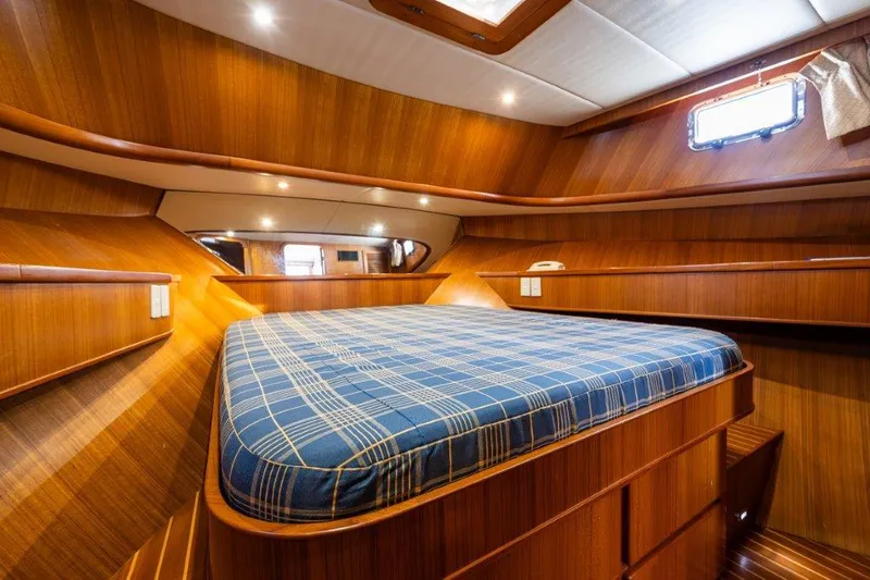 Slide: The Image of Cozy cabin interior of 2000 Symbol 42 Classic Trawler with wood paneling and plaid bedding. - 24