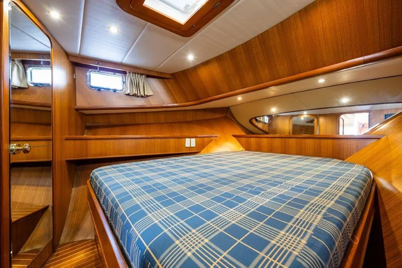 Slide: The Image of Cozy cabin interior of 2000 Symbol 42 Classic Trawler with plaid bedding. - 25