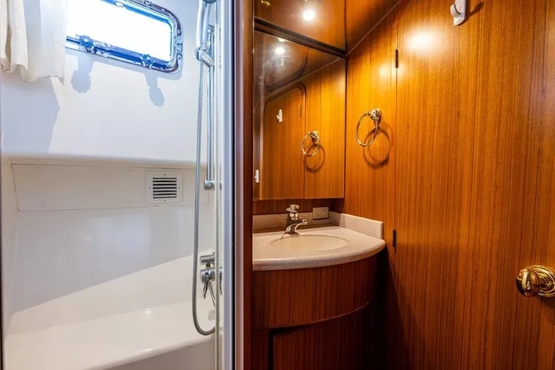 Slide: The Image of Bathroom interior of 2000 Symbol 42 Classic Trawler with wood cabinetry and shower. - 27