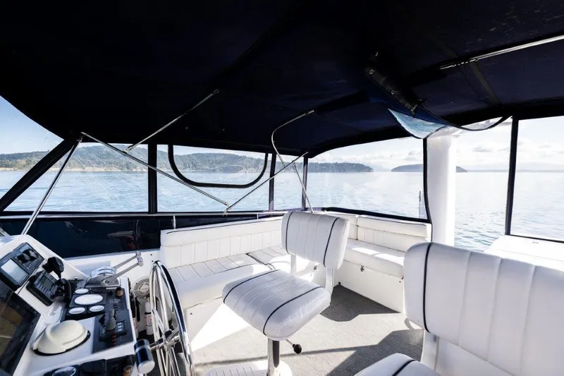 Slide: The Image of Interior of 2000 Symbol 42 Classic Trawler with white seating and ocean view. - 28