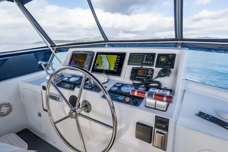 Slide: The Image of Helm of 2000 Symbol 42 Classic Trawler with navigation instruments and steering wheel. - 30