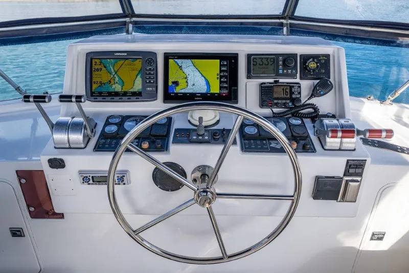 Slide: The Image of Helm of 2000 Symbol 42 Classic Trawler with navigation equipment and steering wheel. - 31