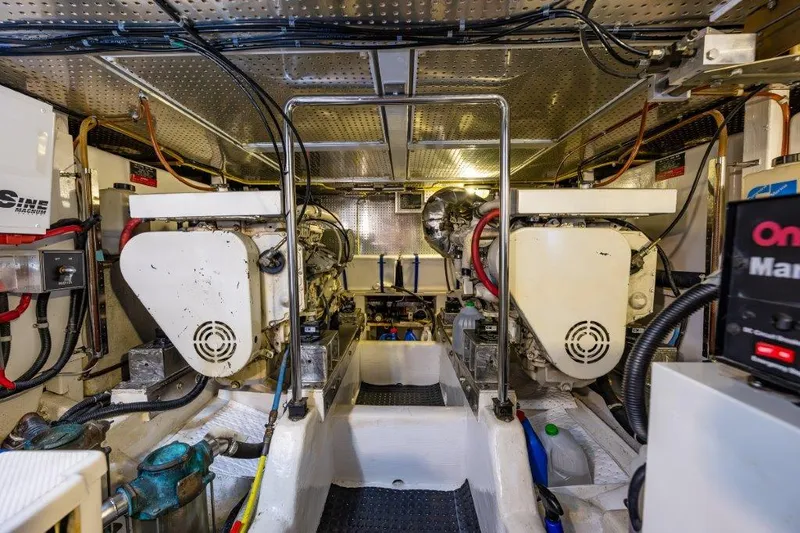 Slide: The Image of Engine room of 2000 Symbol 42 Classic Trawler with dual engines and equipment. - 32