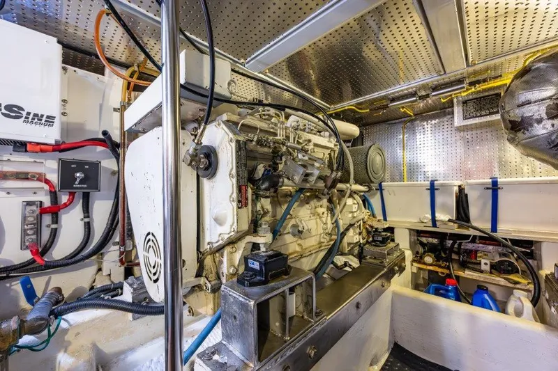 Slide: The Image of Engine room of 2000 Symbol 42 Classic Trawler, showcasing mechanical components and wiring. - 37