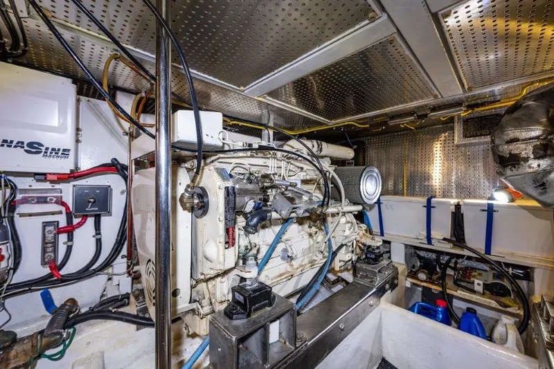 Slide: The Image of Engine room of 2000 Symbol 42 Classic Trawler with visible machinery and wiring. - 39