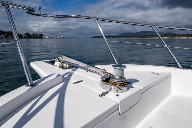 Slide: The Image of Bow of 2000 Symbol 42 Classic Trawler on calm water, featuring anchor winch. - 4
