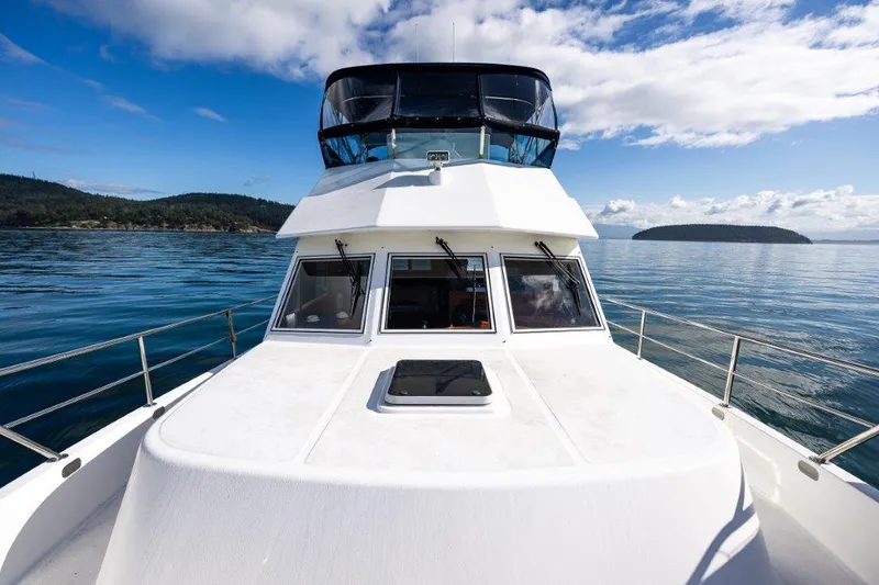 Slide: The Image of Symbol 42 Classic Trawler 2000 on calm waters under a blue sky. - 5