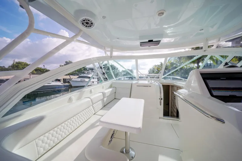 Slide: The Image of 2011 SeaVee 430 Sport Express boat interior with white seating and table. - 15