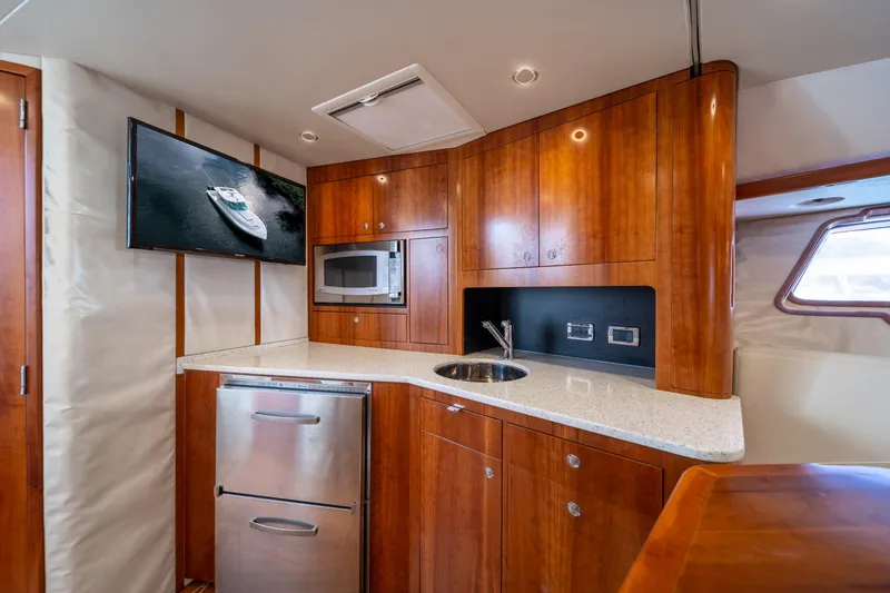 Slide: The Image of Luxurious 2011 SeaVee 430 Sport Express yacht interior with modern kitchen amenities. - 24