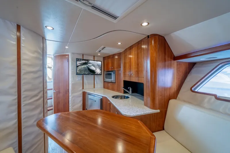 Slide: The Image of Luxurious interior of 2011 SeaVee 430 Sport Express yacht with wood finishes and modern amenities. - 25