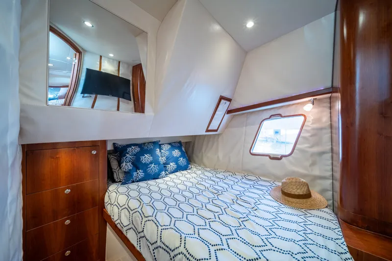Slide: The Image of Luxurious cabin interior of 2011 SeaVee 430 Sport Express yacht with cozy bed and window. - 27