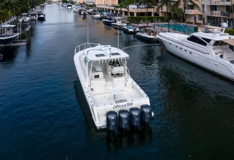 Slide: The Image of 2011 SeaVee 430 Sport Express boat cruising in a canal, surrounded by other yachts. - 8
