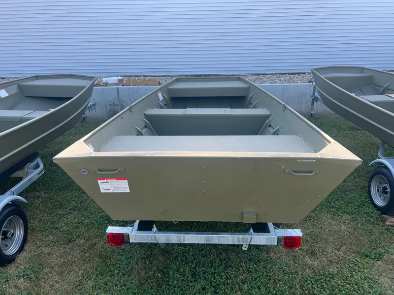 Slide: The Image of 2025 Lund 1448 boat on trailer, displayed outdoors. - 2