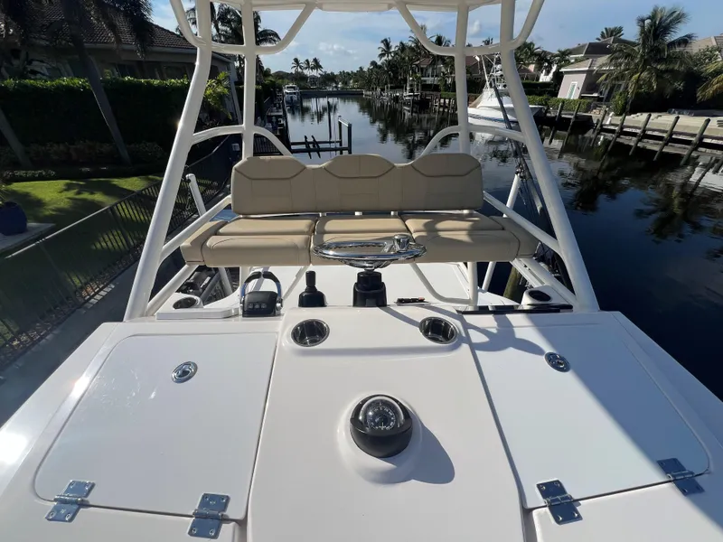 Slide: The Image of 2020 Pursuit S408 boat with seating, docked in a scenic canal setting. - 11