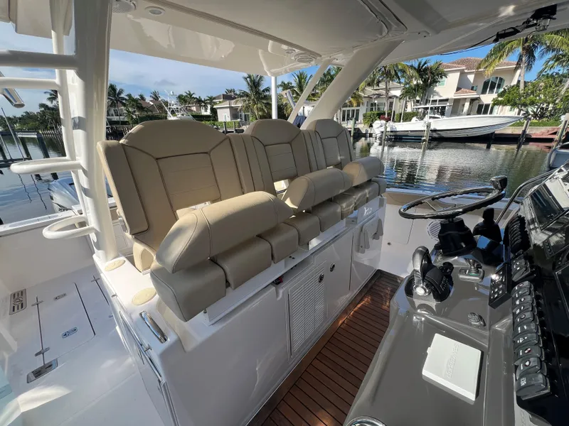 Slide: The Image of Luxurious 2020 Pursuit S408 boat interior with plush seating and modern controls. - 12