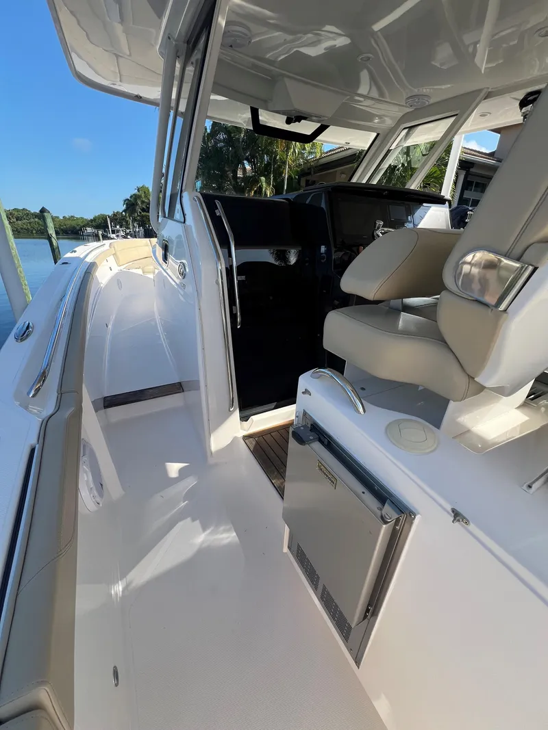 Slide: The Image of 2020 Pursuit S408 boat interior with seating and storage, featuring sleek design and modern amenities. - 13