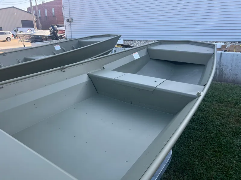 Slide: The Image of 2025 Lund 1648M boat, aluminum hull, parked outdoors on grass. - 4