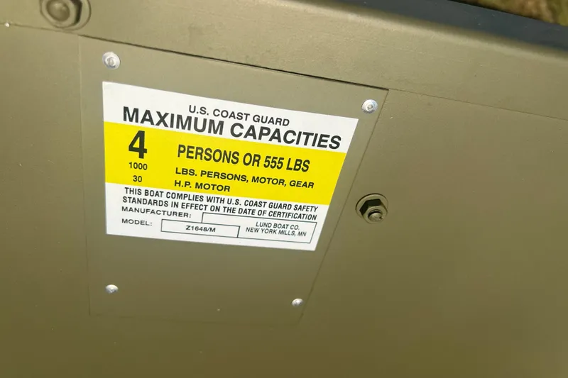 Slide: The Image of Capacity label on 2025 Lund 1648M boat, showing maximum 4 persons or 555 lbs. - 7
