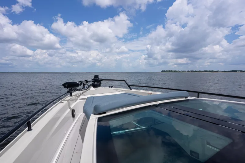 Slide: The Image of 2023 Axopar 37XC CROSS CABIN cruising on open water under a cloudy sky. - 14