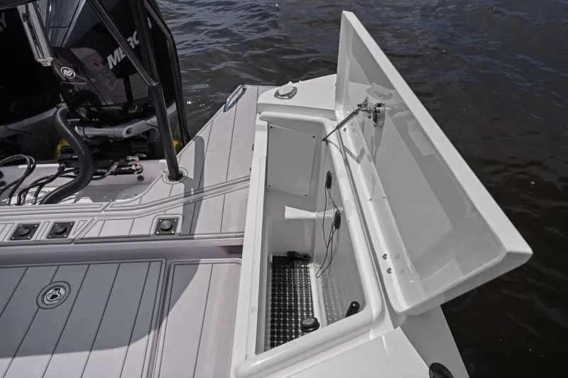 Slide: The Image of Axopar 37XC CROSS CABIN 2023 boat deck with open storage compartment. - 15