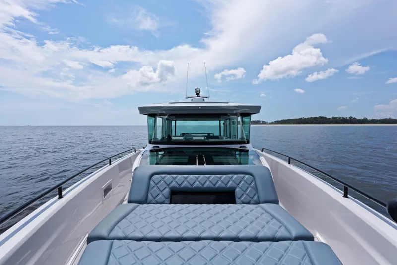 Slide: The Image of 2023 Axopar 37XC CROSS CABIN on open water, featuring sleek design and spacious seating. - 18