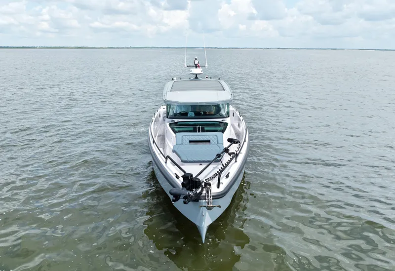 Slide: The Image of 2023 Axopar 37XC CROSS CABIN boat on calm water under cloudy sky. - 22