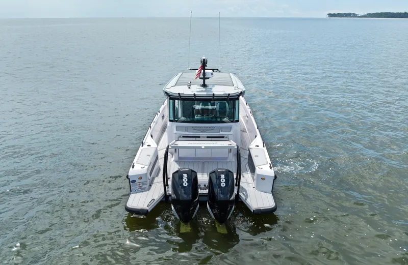 Slide: The Image of 2023 Axopar 37XC CROSS CABIN boat on open water, rear view. - 23