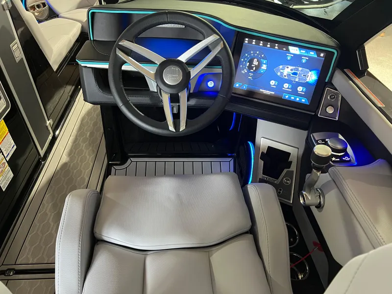 Slide: The Image of 2025 MasterCraft XT23 boat cockpit with modern steering wheel and digital display. - 8