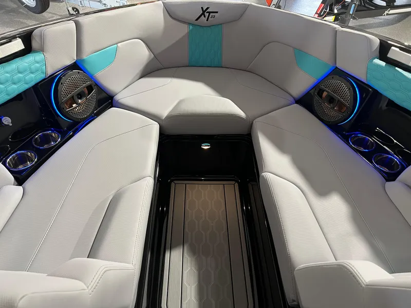 Slide: The Image of 2025 MasterCraft XT23 boat interior with modern seating and blue accents. - 9