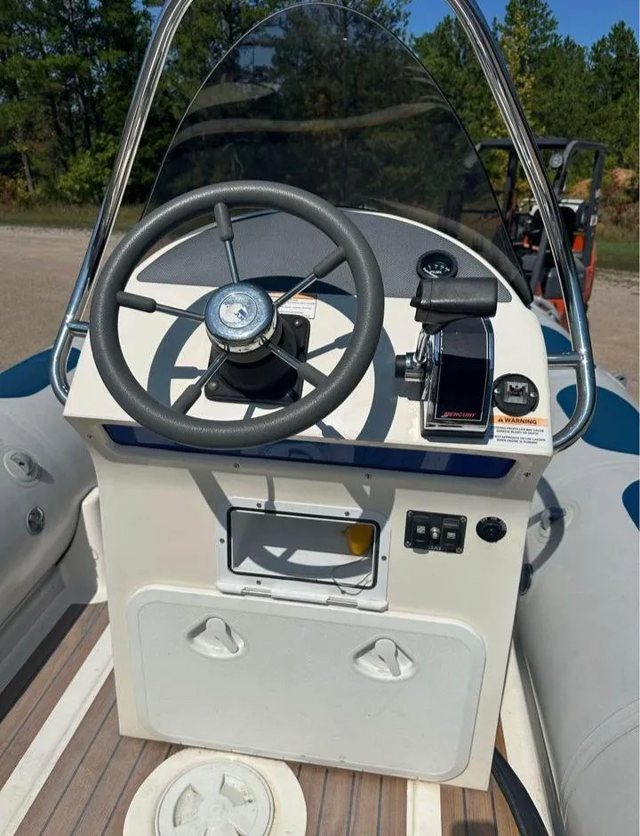 Slide: The Image of 2008 Valiant RIBs V520 boat console with steering wheel and controls, outdoors. - 3