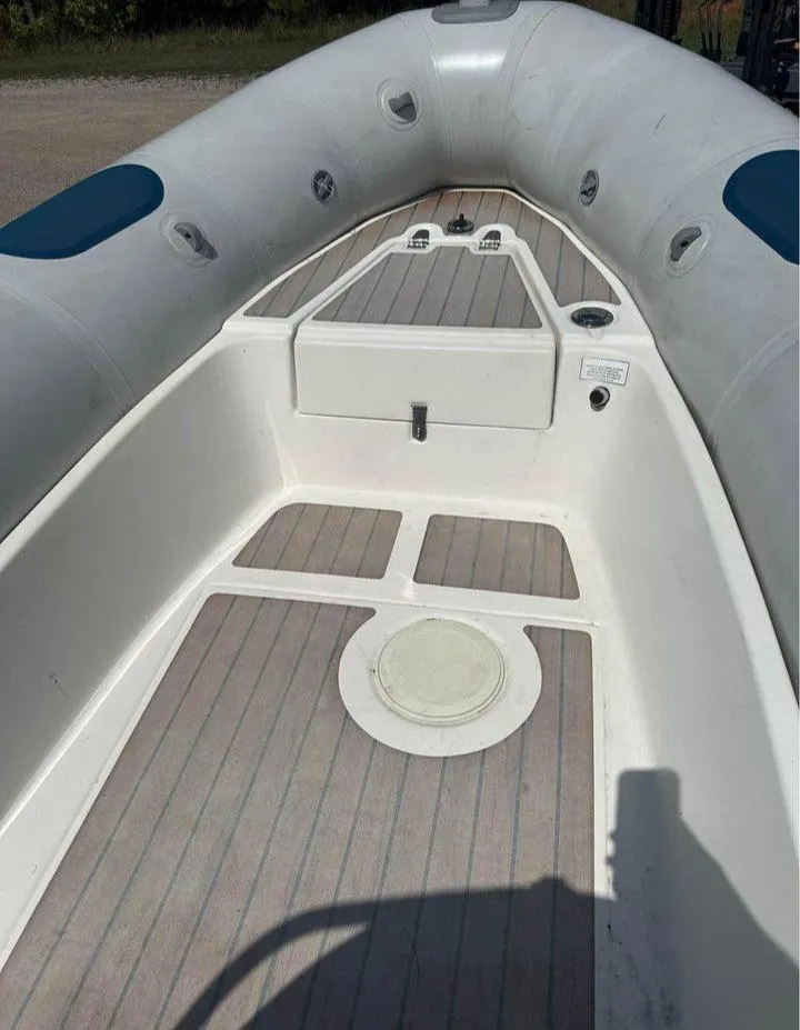 Slide: The Image of 2008 Valiant RIBs V520 boat interior with white and gray deck, blue accents. - 4