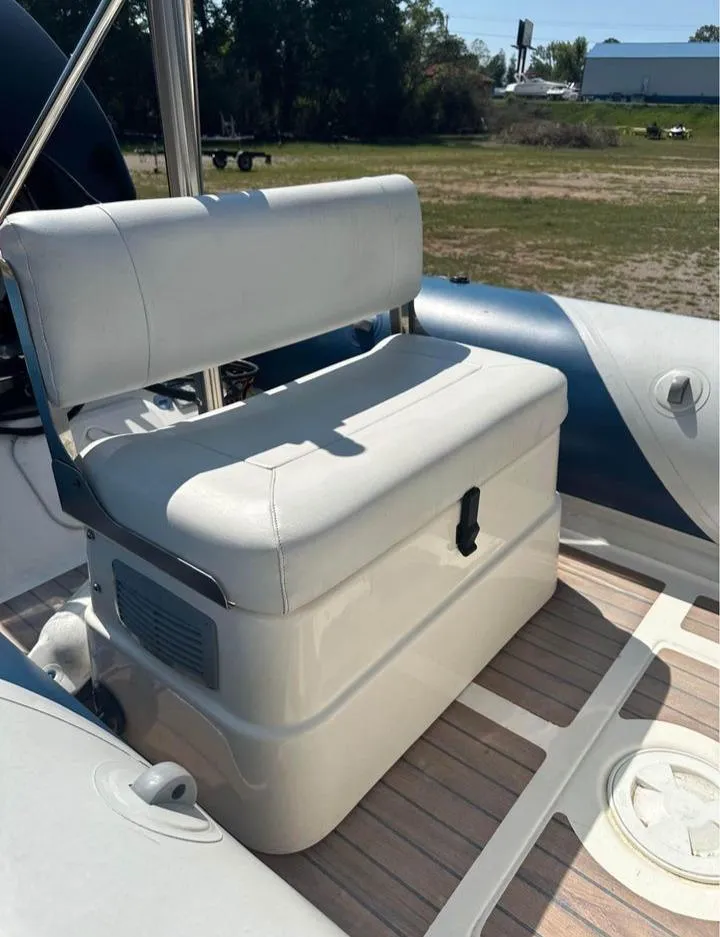Slide: The Image of 2008 Valiant RIBs V520 boat seat with white cushion and storage compartment. - 5