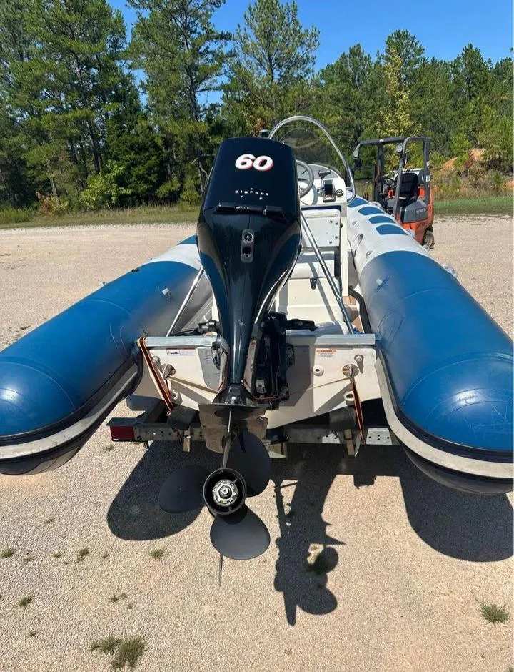 Slide: The Image of 2008 Valiant RIBs V520 inflatable boat with 60 HP outboard motor, parked outdoors. - 8