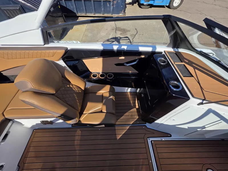 Slide: The Image of 2025 Yamaha Boats 222SE interior with tan seating and wood-style flooring. - 13
