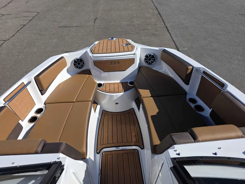 Slide: The Image of 2025 Yamaha Boats 222SE interior with brown seating and wood accents. - 6