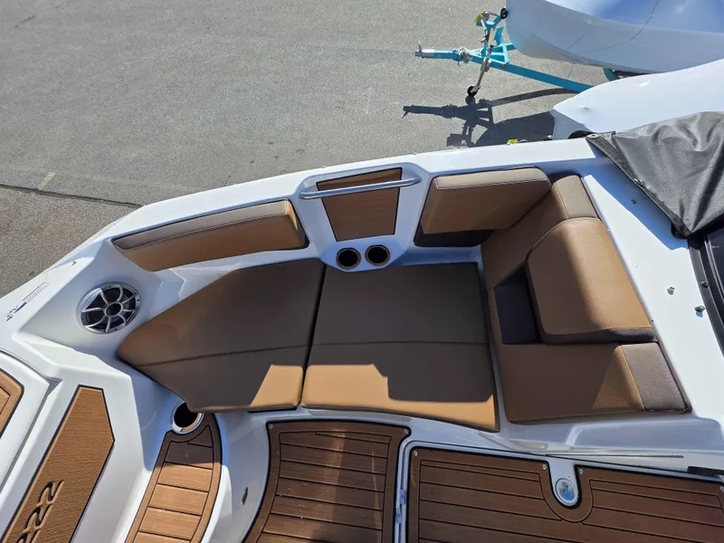 Slide: The Image of 2025 Yamaha Boats 222SE interior with tan seating and wood accents. - 8