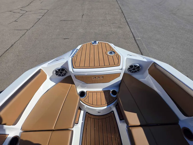 Slide: The Image of 2025 Yamaha Boats 222SE bow with tan seating and wood accents, showcasing modern design. - 9