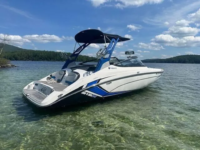 Slide: The Image of 2019 Yamaha Boats 212X on clear lake under blue sky. - 3