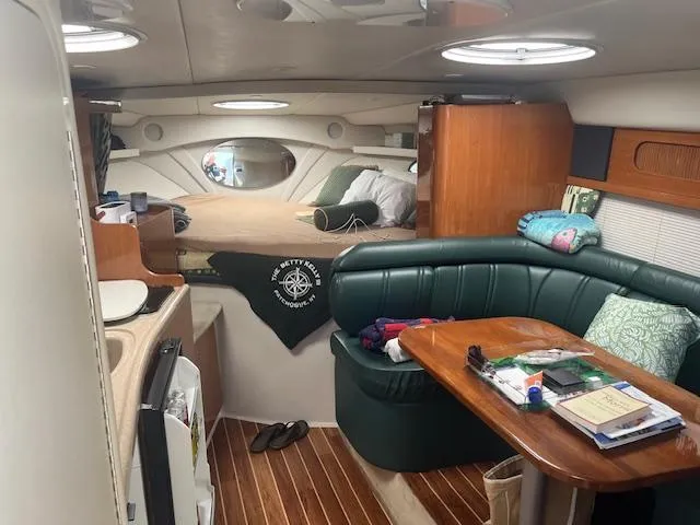 Slide: The Image of Interior of 2000 Four Winns 328 Vista boat with cozy seating and sleeping area. - 15